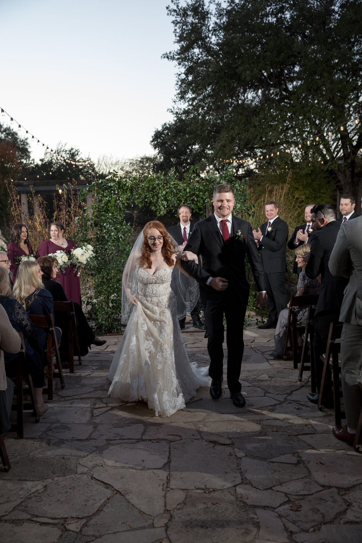 Recessional at the Wildflower Center — couple walking down the aisle at golden hour