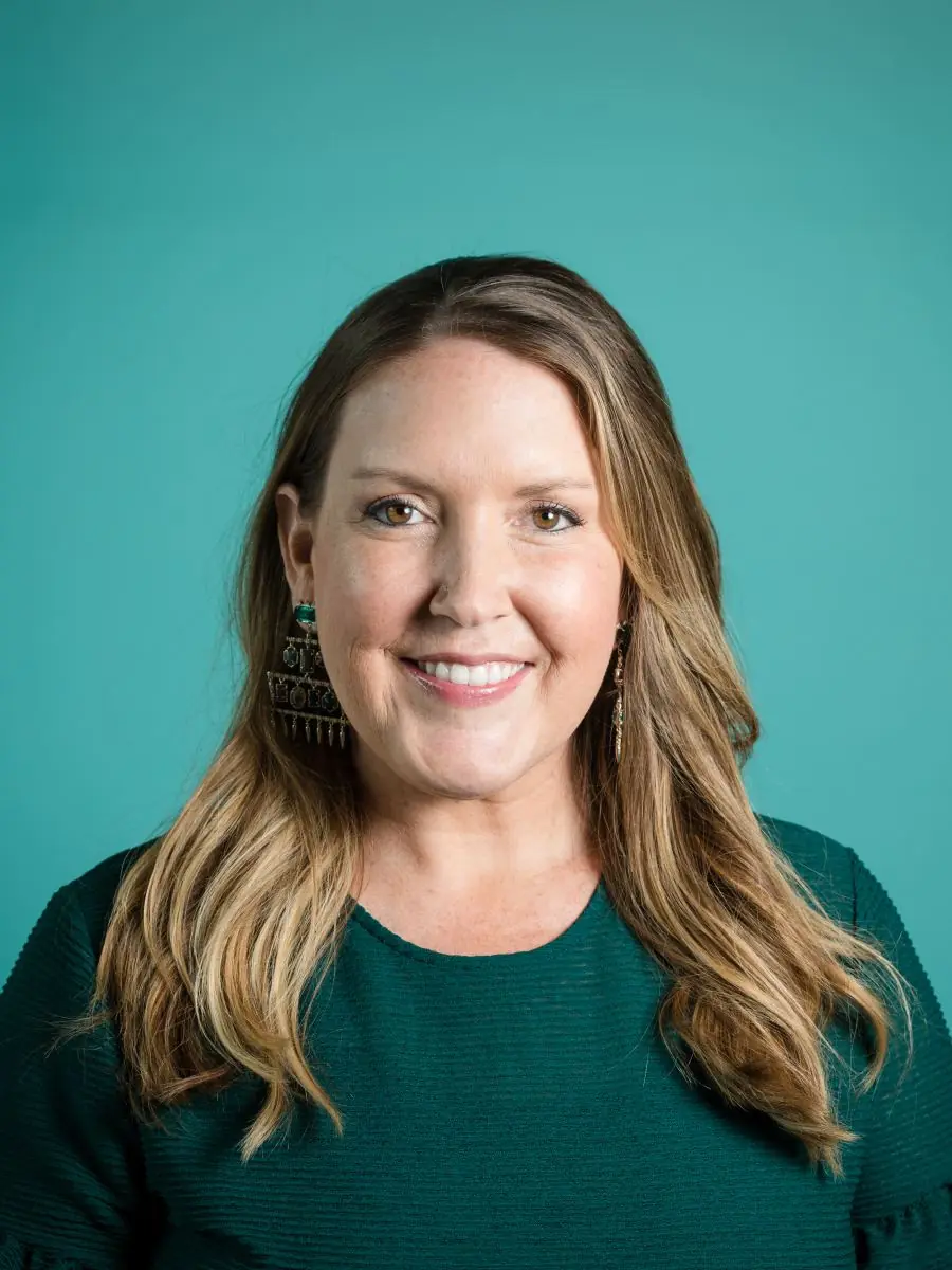 studio portrait on a teal backdrop