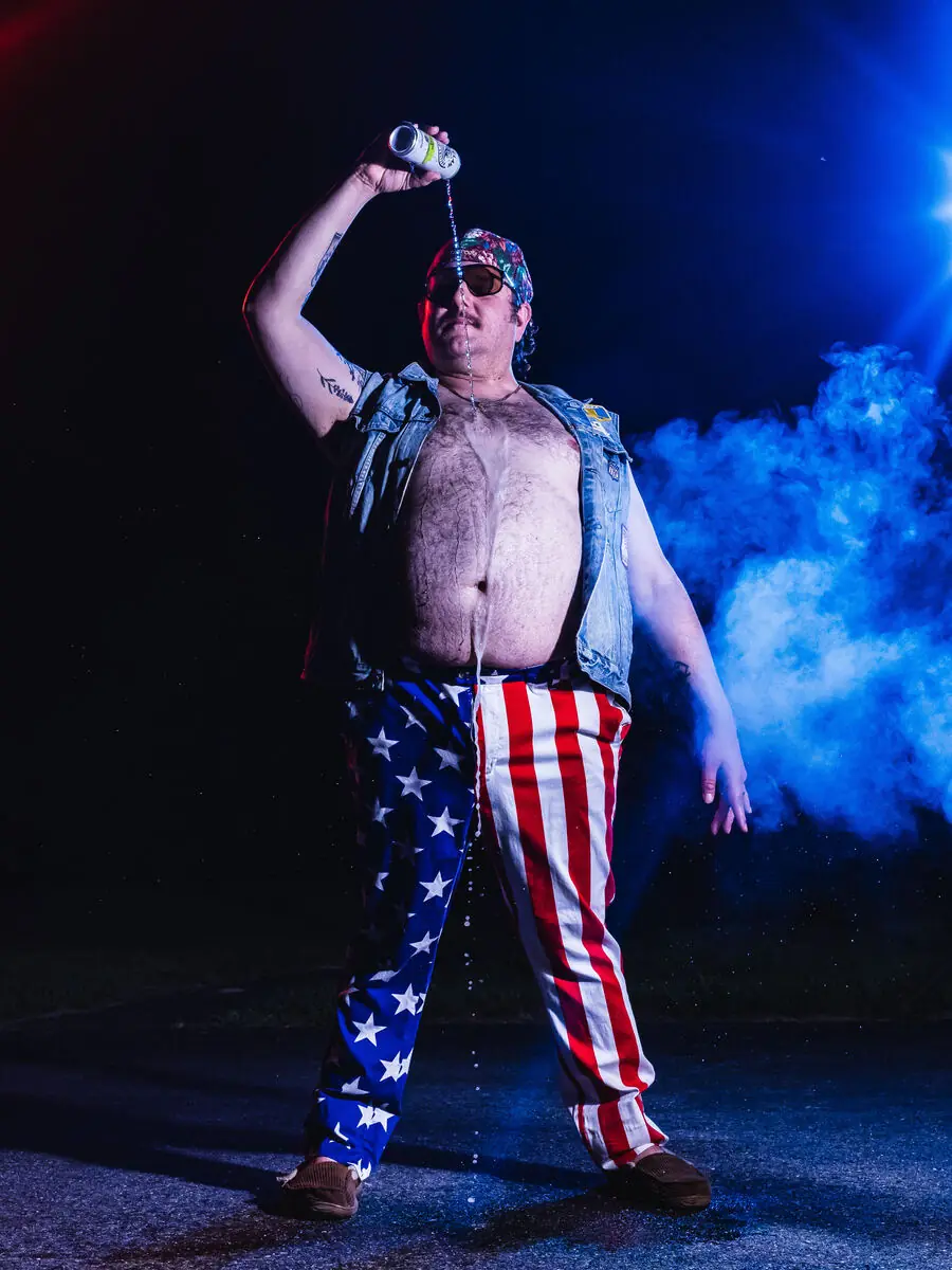 musician in flag pants standing in smoke