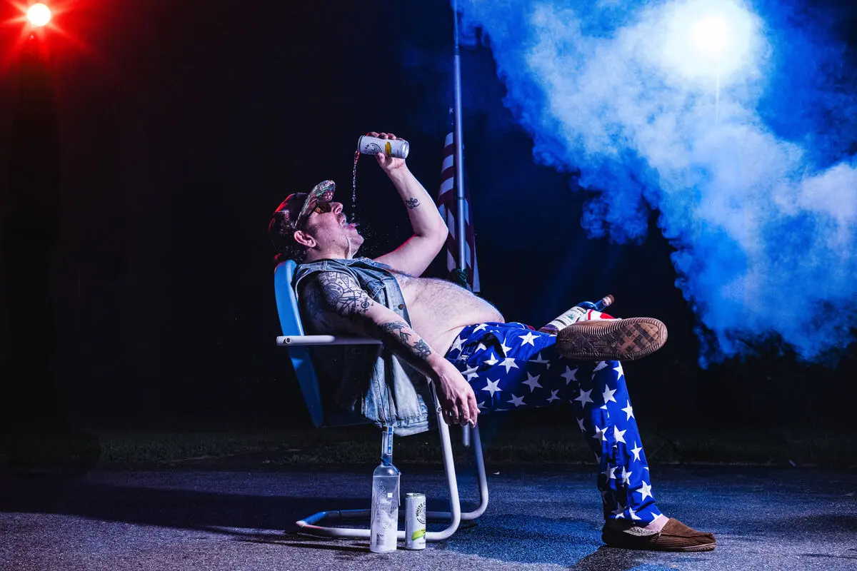 musician in flag pants in a lawn chair