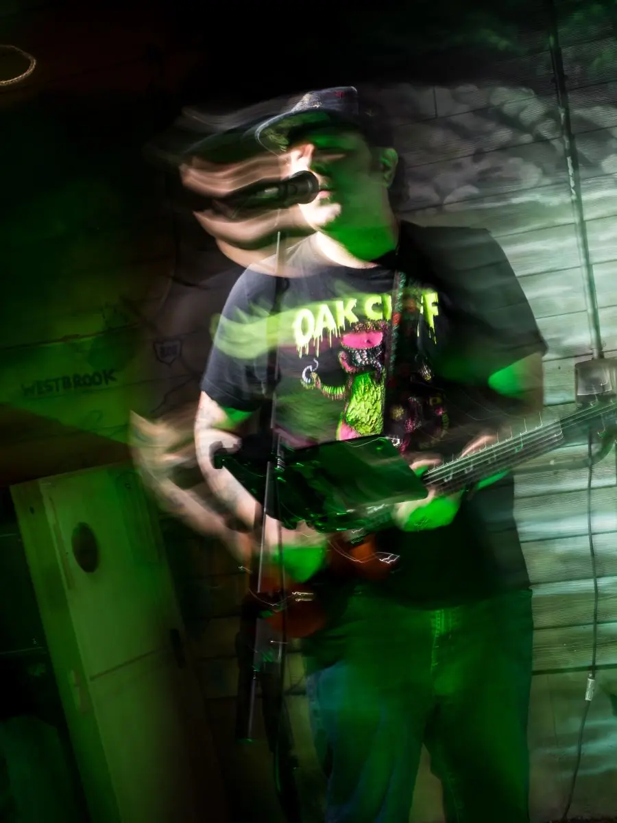 Mainely Texans guitarist singing on stage