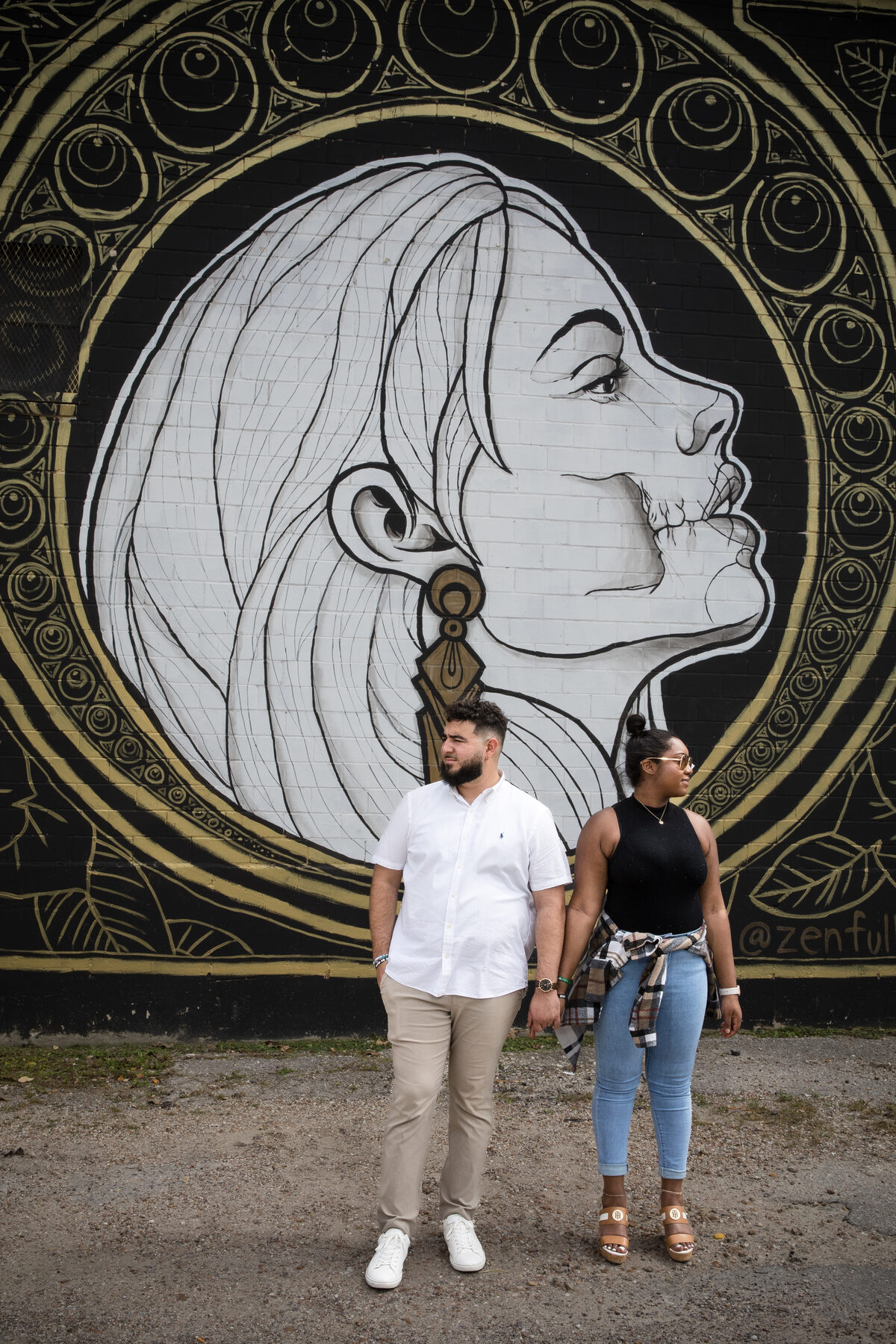 Couple in front of zentful Austin mural