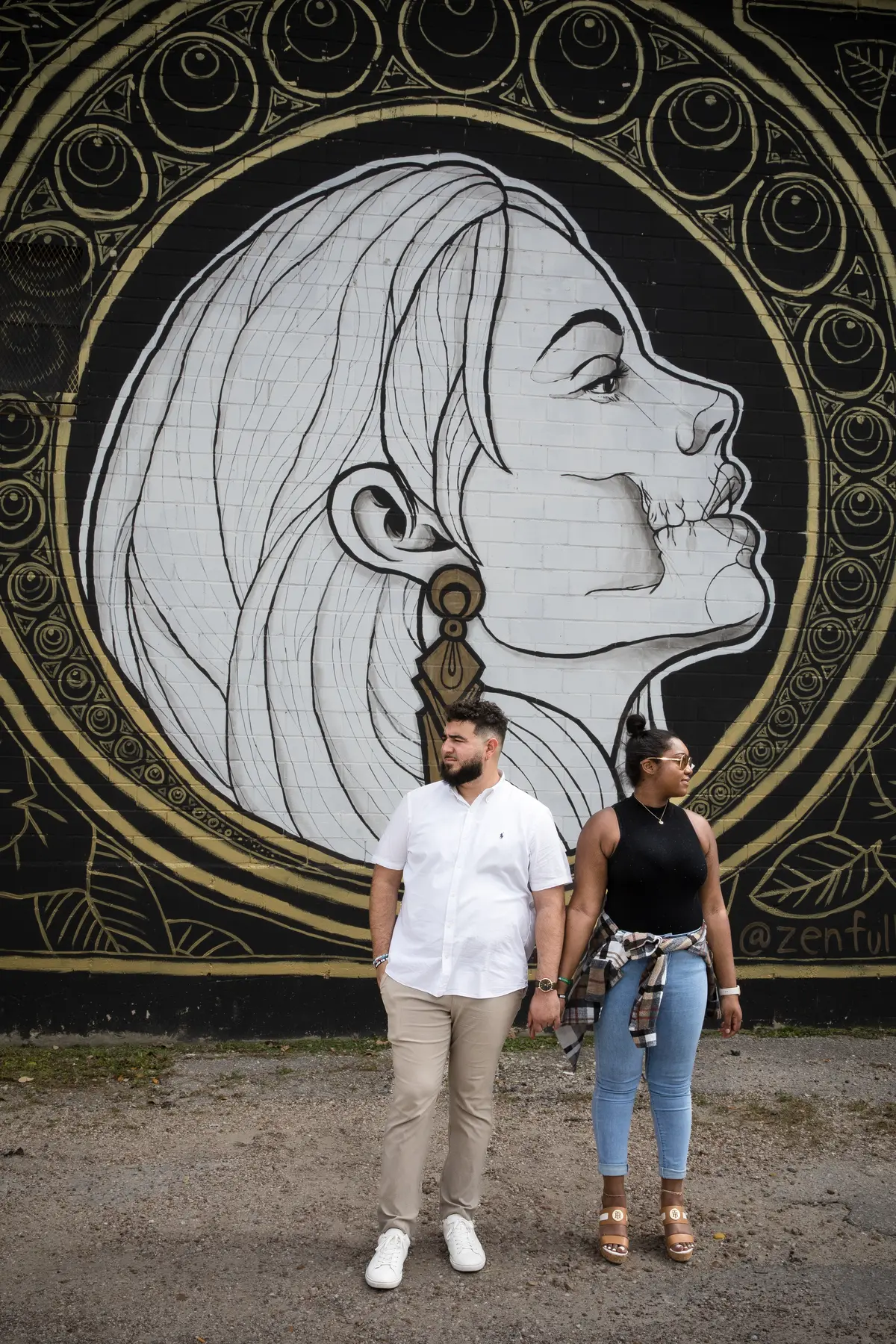 Couple in front of zentful Austin mural