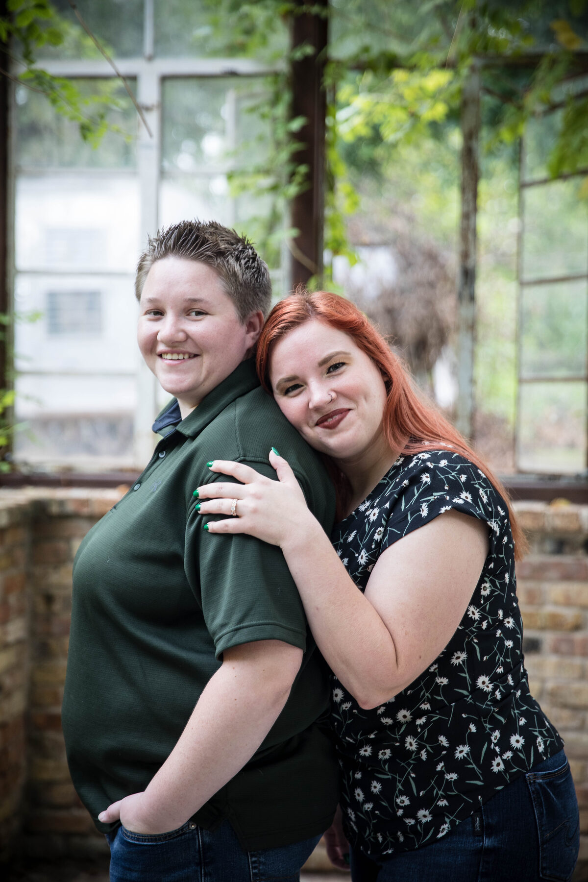 Two women in greenhouse engagement session