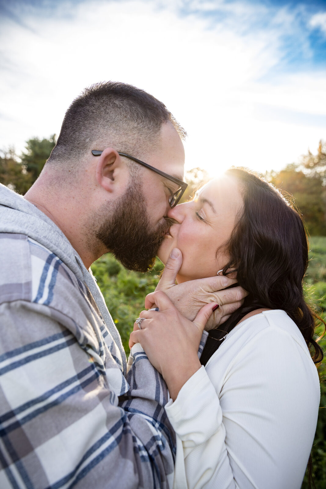 Couple kissing under a bright blue sky