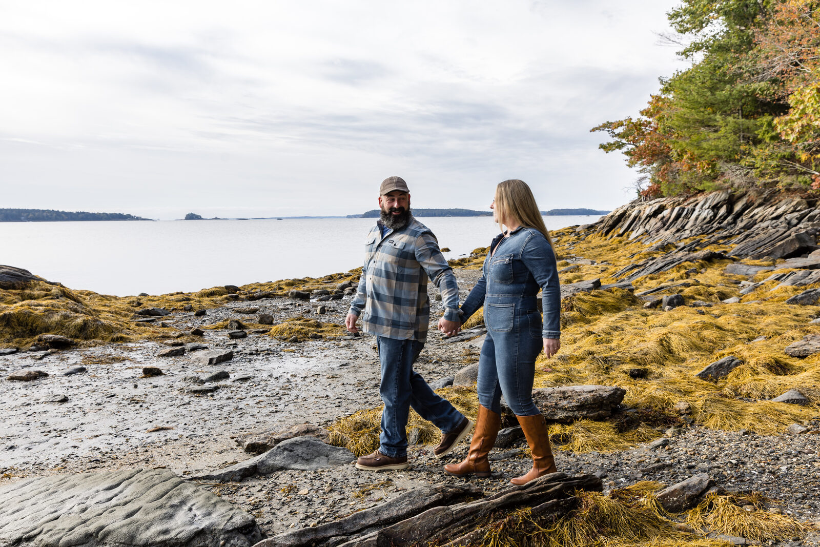 Couple walking a rocky coastline