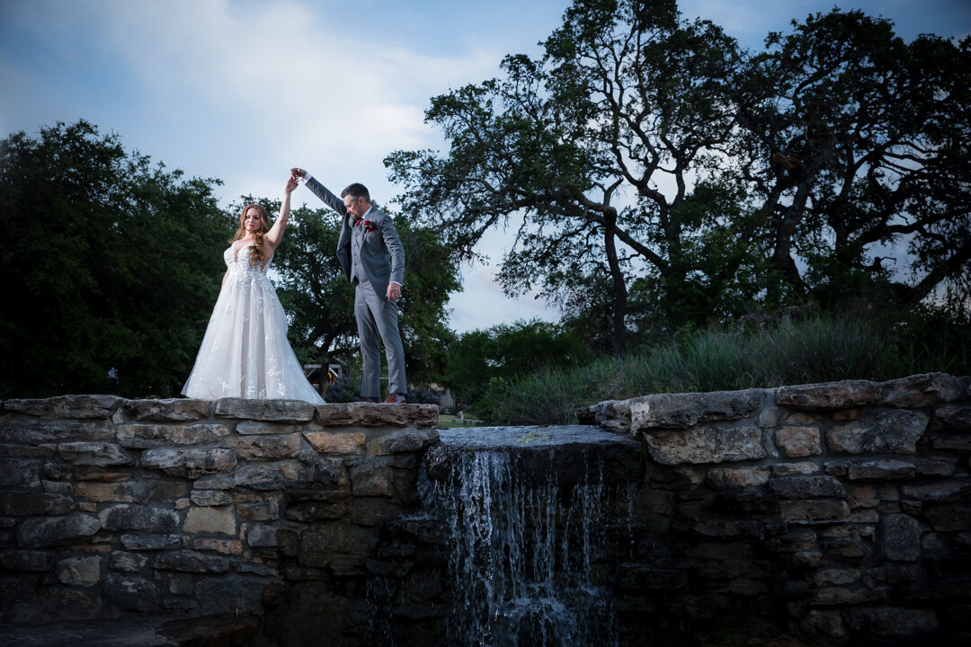 Couple on Hill Country stone waterfall bridge