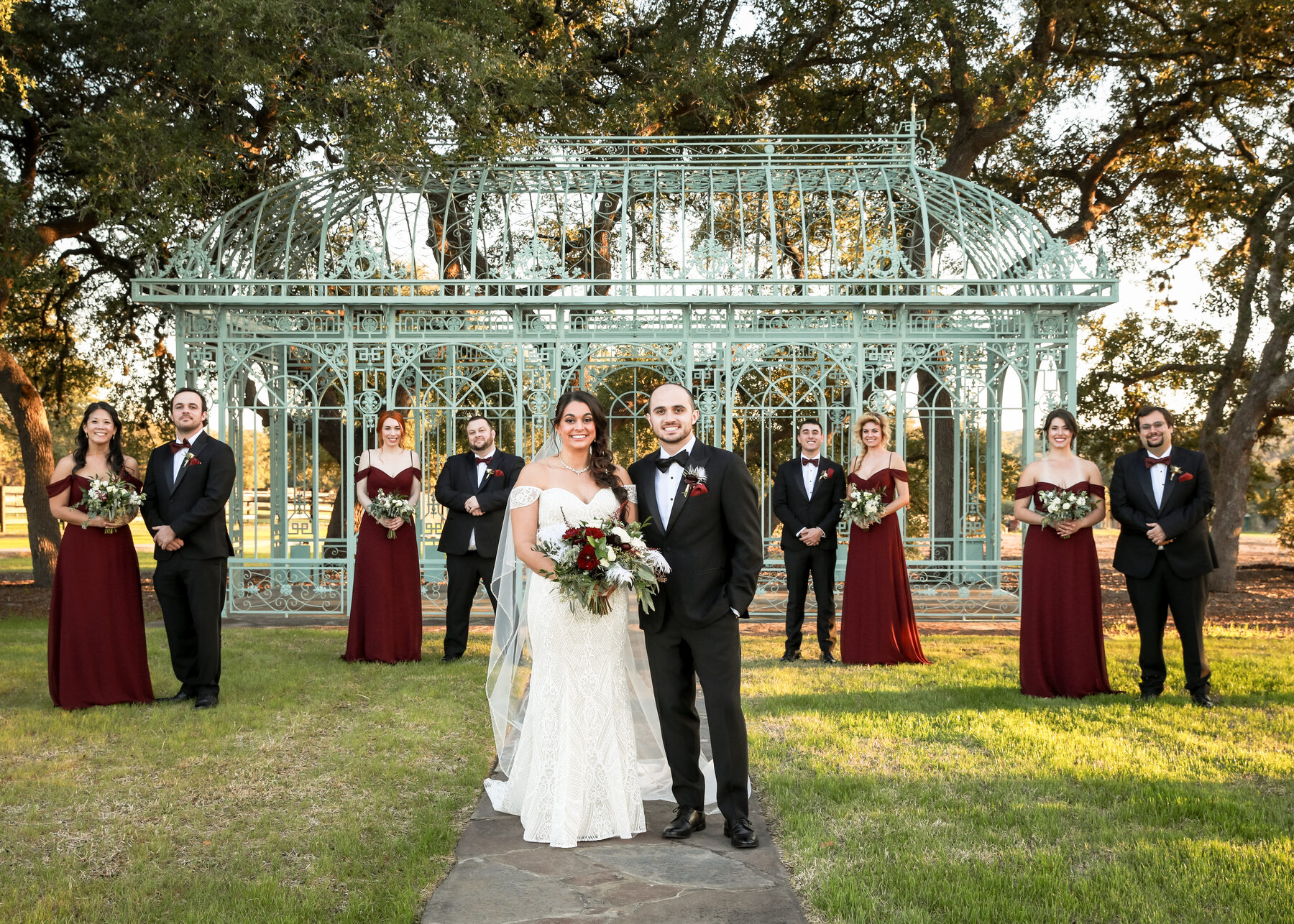 Wedding party at gazebo with burgundy dresses