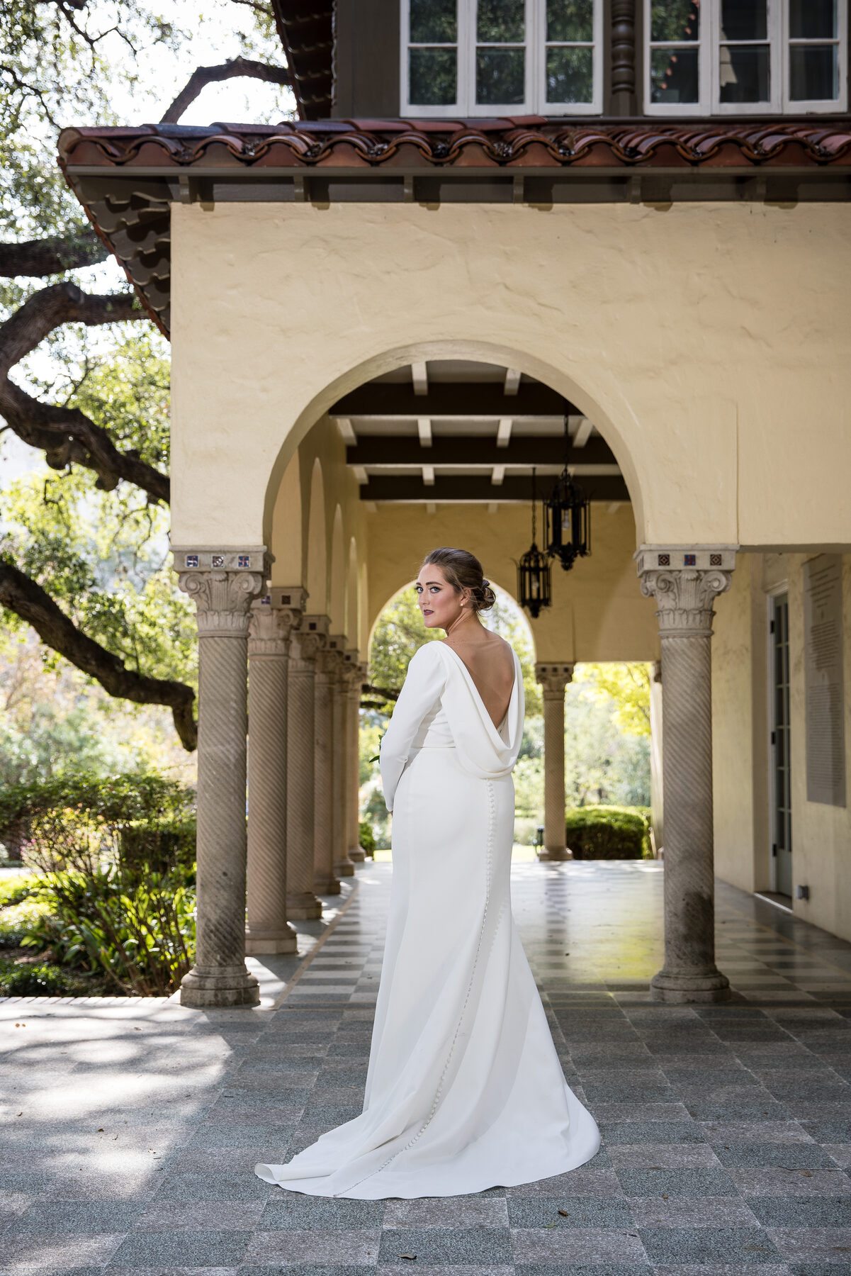 Bride from behind under stone archway